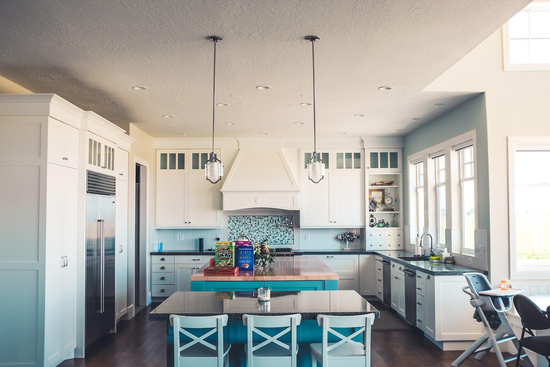 white kitchen with island and table